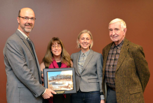 Lake County Stormwater Management Commission Executive Director Mike Warner (left) presents the 2015 “Education, Outreach, and Media Award’ to (from left) BACT Conservation@Home Coordinator Beth Adler, BACT Executive Director Lisa Woolford, and BACT Board President Stevenson Mountsier.